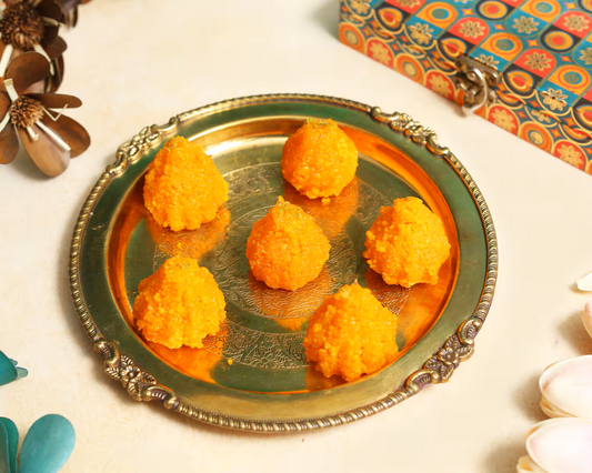 Nutty Ghee Sweets motichoor modak in Gurgaon six bright orange traditional Indian sweet dumplings on a brass plate